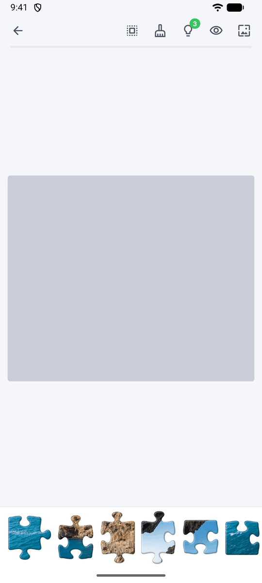A new puzzle: an empty board with the jigsaw pieces lined up in the scrolling tray at the bottom