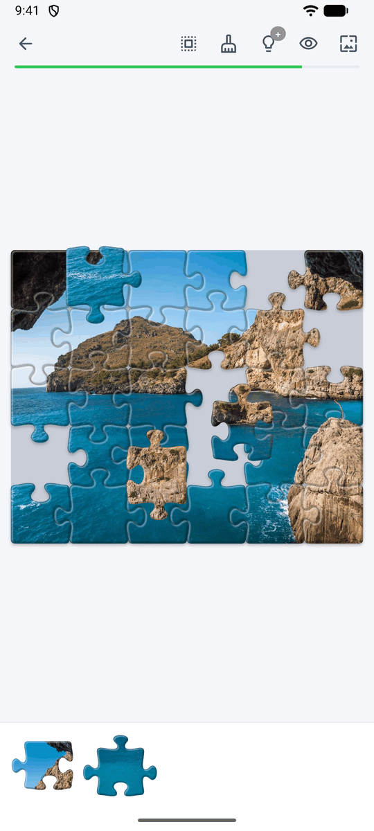 A seaside cliff puzzle that is almost finished, showing classic tab-and-blank jigsaw pieces and their seams